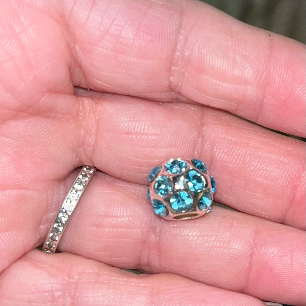 Light blue crystals on a silver tone base.